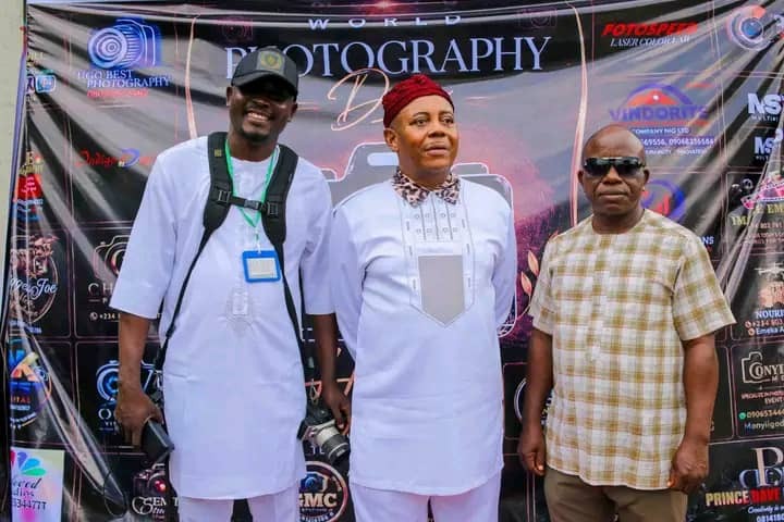 ISPPAN Imo State Chapter President, Comrd. Onyeahialam Chibueze T. (left), with distinguished guests at the World Photography Day 2026 banner backdrop, GLO RAN HOTEL, Owerri.